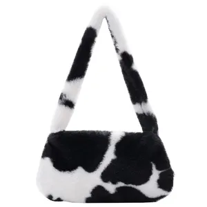 Chic black and white cow print plush underarm bag with soft faux fur texture for women