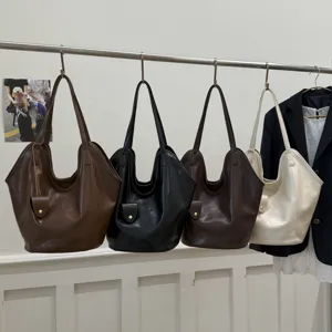 Detailed view of large capacity tote bags in four versatile colors hanging on a rack