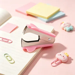 Cute pink staple remover office tool detail view, portable stationery accessory for desk.