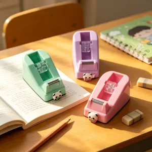 Close-up detail of cute pastel panda tape dispensers on wooden desk, ideal for stationery.