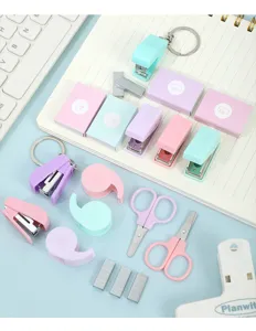 Mini pastel stationery set detail showcasing cute portable staplers, tape and scissors.