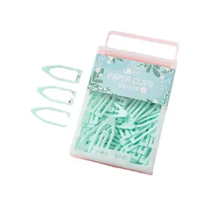 Pastel green boat shaped paper clips with clear plastic storage box for school office use.