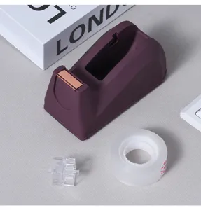 Detail view of the Morandi purple desktop tape dispenser with clear tape and spool.