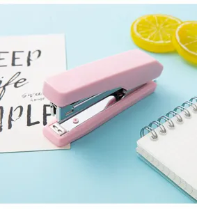 Macaron pink mini portable stapler, compact hand-held stationery for school and office use.