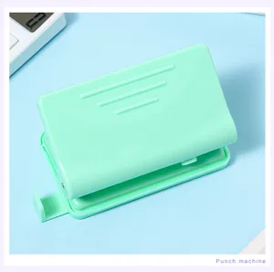 Macaron green dual-hole paper puncher, portable stationery tool for binder notebooks.