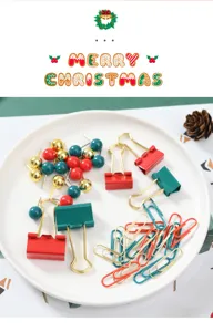 Weihnachts-Briefpapier-Set mit roten grünen Büroklammern, Papierschnipseln auf einem weißen Teller.