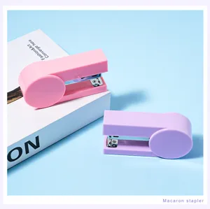 Portable mini macaron stapler detail shot, cute pink and purple desktop office stationery tool.