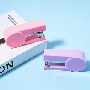 Portable mini stapler set in pink and purple colors for office and school stationery use.