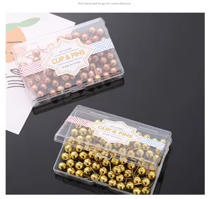 Dekorative goldene und roségoldene Rundkopf-Pinnadeln in klaren Kunststoff-Aufbewahrungsboxen.