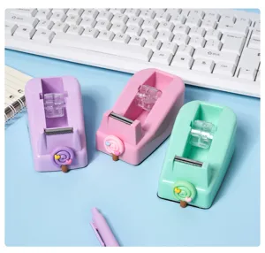Close-up detail shot of macaron color lollipop tape dispensers in pastel shades for office.