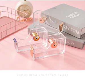 Acrylic rose gold tape dispenser detail showcasing transparent body and metal core.