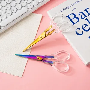 Transparent acrylic handle scissors with gold and rainbow metal blades for office and DIY crafts.