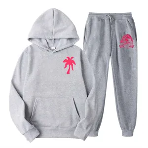 Grey fleece tracksuit set with pink palm tree print, comfortable hoodie and matching sweatpants.