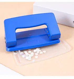 Heavy duty two-hole paper punch with confetti tray, blue office stationery tool for desk use.