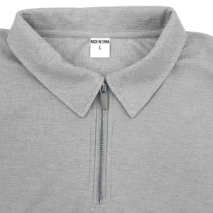 Close-up detail of gray waffle knit polo shirt collar and zipper placket for men summer.