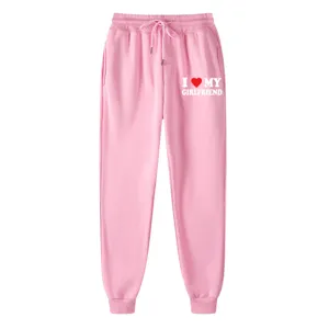 Pink fleece sweatpants featuring slogan letter print, elastic drawstring waist and cuffed ankles.