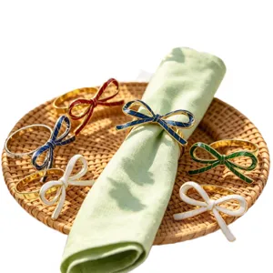 Metal enamel bow napkin rings set for table decor, elegant dining accessories for hotel.