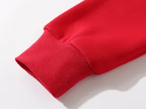 Red sweatshirt sleeve cuff detail close up view, comfortable knitted ribbed design.