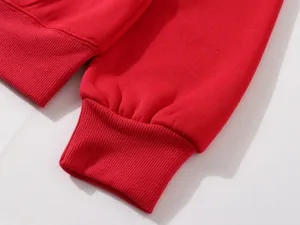 Red sweatshirt cuff detail, comfortable ribbed fabric, close-up view of casual apparel.
