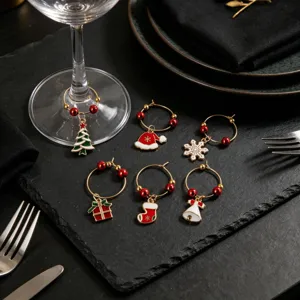 Gros plan des breloques de verre à vin de Noël en métal sur table de fête, décoration.