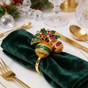 Close-up of Christmas bell napkin ring, alloy and rhinestone details, holiday table decor.