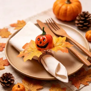 Autumn pumpkin maple leaf napkin ring detail, rustic Thanksgiving table decor setup close up