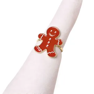 Detail shot of red gingerbread man napkin ring on white cloth, Christmas holiday table decor.