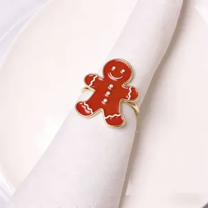 Close-up detail of the red enamel gingerbread man napkin ring with white icing and pearl accents.