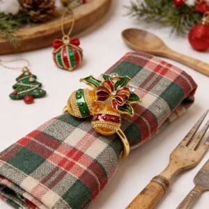 Detailed view of a Christmas bell napkin ring with red green enamel and rhinestones for tables.