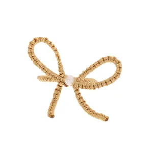 Linen fabric bow napkin ring detail with pearl decoration for elegant European dining table.