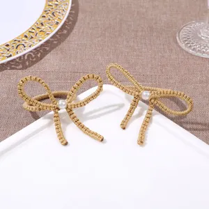 Gold woven bow napkin ring detail, exquisite pearl center accent for table decor.