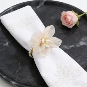 Elegante portasciugamani con fiore di perla e tovagliotto ricamato per decorazioni.