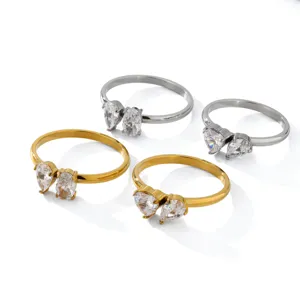Detailed view of stainless steel dual zircon rings in gold and silver, elegant open style.