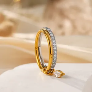 Close-up of double-layer stacked stainless steel ring with marquee zircon pendant and clear stones.