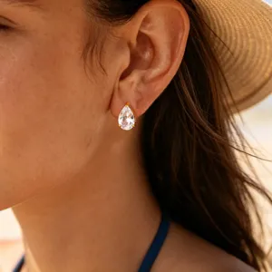Elegant pear-shaped cubic zirconia stud earrings with gold setting, perfect for daily wear.