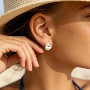Close-up detail of a stunning oval cubic zirconia stud earring worn gracefully by a model.