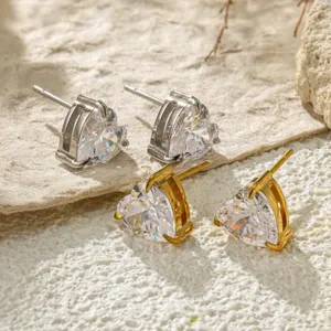 Close-up detail of stainless steel heart zirconia stud earrings in gold and silver colors.