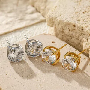 Close-up detail of stainless steel four-prong cubic zirconia stud earrings in dual tones.