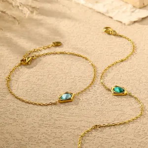 Gold plated chain bracelet with colorful irregular zirconia stones, delicate jewelry detail.