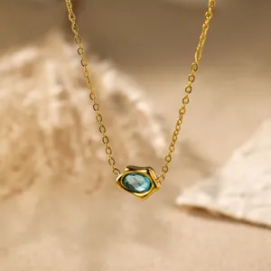 Detailed close-up shot of the gold-plated irregular blue zircon pendant necklace sparkle.