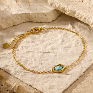 Detail shot of a gold-plated irregular blue zircon bracelet, elegant and chic daily jewelry.