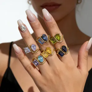 Close-up detail of double stone colorful cubic zirconia geometric gold rings layered.
