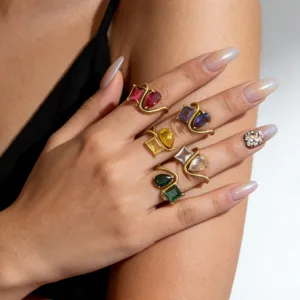 Close-up of exquisite 18K gold plated multi-color zircon twin rings, geometric stacking.
