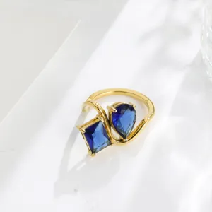 Luxury 18K gold plated double stone ring with blue cubic zirconia geometric open design.