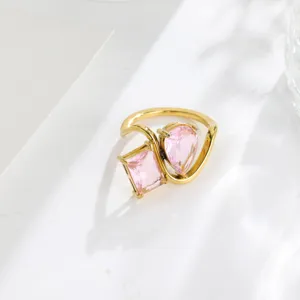 Detailed view of 18K gold plated dual cubic zirconia ring, elegant geometric open design.