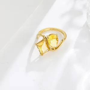 Close-up detail of a chic 18K gold-plated double yellow cubic zirconia open ring design.