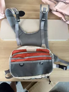 Detail view of tactical fly fishing chest pack with multi pockets and breathable mesh straps.