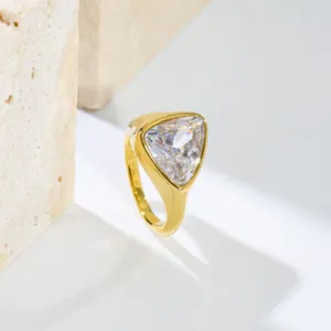 Gold stainless steel ring featuring a large trillion-cut cubic zirconia for daily fashion.
