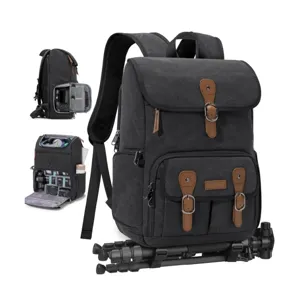 Details view of canvas camera backpack showing interior compartment and bottom tripod strap.