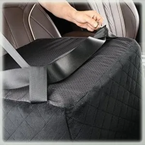 Pet car seat detail view, black quilted fabric pet booster seat installation and strap setup.
